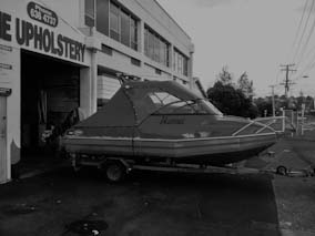 Boat canopy and backdrop with sides, using red Sunbrella canvas and Vinistar clear PVC.